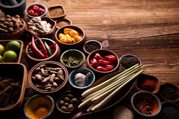 Thai food background. Ingredients in teak bowls on rustic wooden table.
