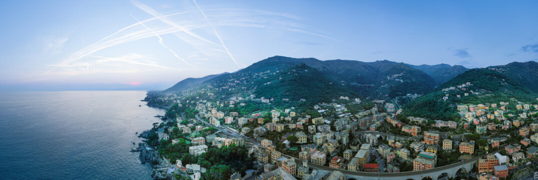 Holidays in Italy. &bull;	Sunset on the mediterranean. Sea coast of Liguria near Genoa. Traditional architecture of Italy.