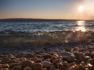 Wave in the sunset over the adriatic sea at the Croatian coast.