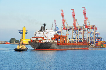 Tugboat assisting general cargo ship