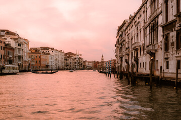 From the boat in the middle of a canal in venice at sunset.