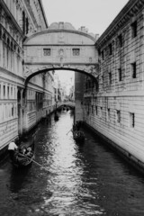 A view through a narrow water with gondolas.