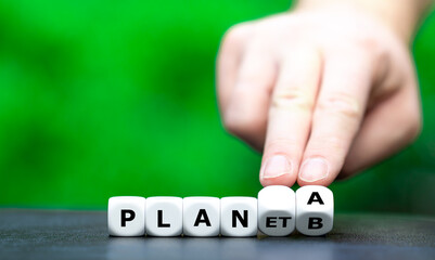 Symbol to fight against climate change. Hand turns dice and changes the expression "planet b" to "plan a".