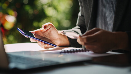 Hands holding credit card and using laptop for shopping online. New normal lifestyle of using...