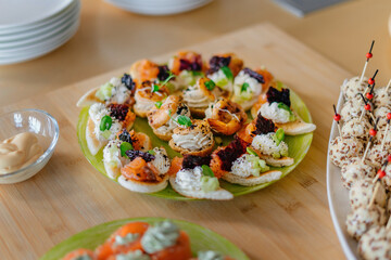 Profiteroles with cream cheese, smoked salmon, decorated with microgreens.