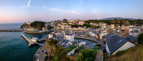 Fototapeta premium Luarca, Asturias Spain, Europe. Landscape with fishing and pleasure port with boats, harbor, sea and beach. Touristic destination, panoramic sunset