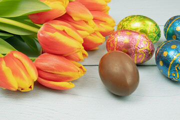 easter eggs and tulips on a wooden background