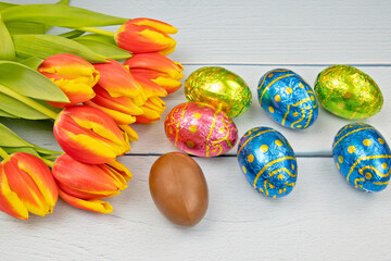 easter eggs and tulips on a wooden background