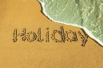 Das Wort holiday in den Sand geschrieben