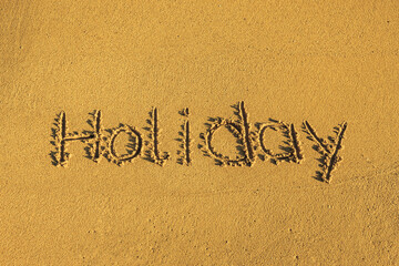 Das Wort holiday in den Sand geschrieben