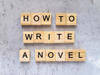 Top view of words HOW TO WRITE A NOVEL made from wooden letters. The concept of writing skills.