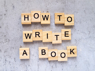 Top view of words HOW TO WRITE A BOOK made from wooden letters. The concept of writing skills.