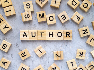 Top view of the word AUTHOR. Wooden letters add up to words.