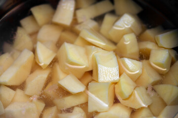 Peeled potato in water