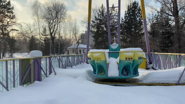 Old  carousel in an abandoned amusement park in winter with snow