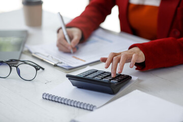 Close up of Business woman accountant or financial expert analyze business report graph and finance chart at corporate office. Concept of finance economy, banking business and stock market research.