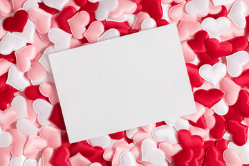 Fototapeta Valentine's Day background. White postcard mockup on background of pink and white hearts. Saint Valentine. Flat lay, top view, copy space obraz
