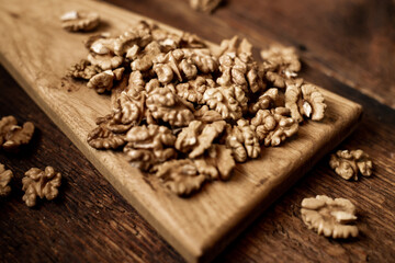 Peeled walnuts. On a wooden background. Healthy food. Natural background.