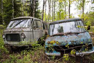 Old rusty abandoned van in the woods