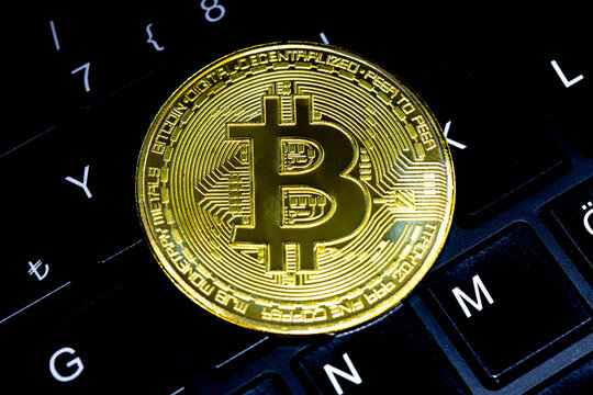 Bitcoin representation coin on keyboard keys. Bitcoin symbol in selective focus. Cryptocurrency, stock market, blockchain, digital money concept.