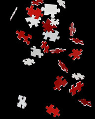 Red jigsaw pieces falling 