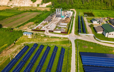 Aerial view of electrical power plant with rows of solar photovoltaic panels for producing clean ecological electric energy at industrial area. Renewable electricity with zero emission concept