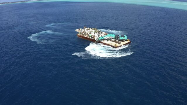 Aerial view, flight over plastic garbage, garbage - disposal. Waste transportation with an excavator, South Male Atoll Maldives, Asia