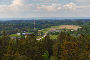 Obraz premium View from the observation tower built on the highest Baltic mountain Suur-Munamagi, tops of tall green spruces, summer daytime. Estonia.
