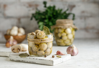 Marinated champignons in a jar. Pickled mushrooms with spices