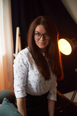 a girl with dark long hair in a red beret and a white blouse, retro style. Indoor soft light.