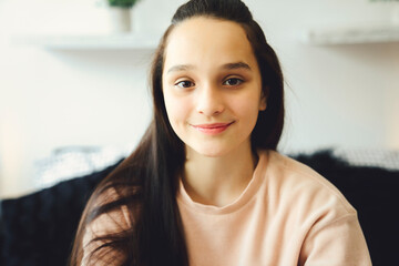 Teen spending time relaxing on bedroom at home