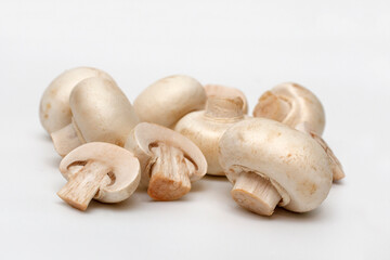 Fototapeta na wymiar Champignons, close-up, on white background. Raw mushrooms ready for cooking.