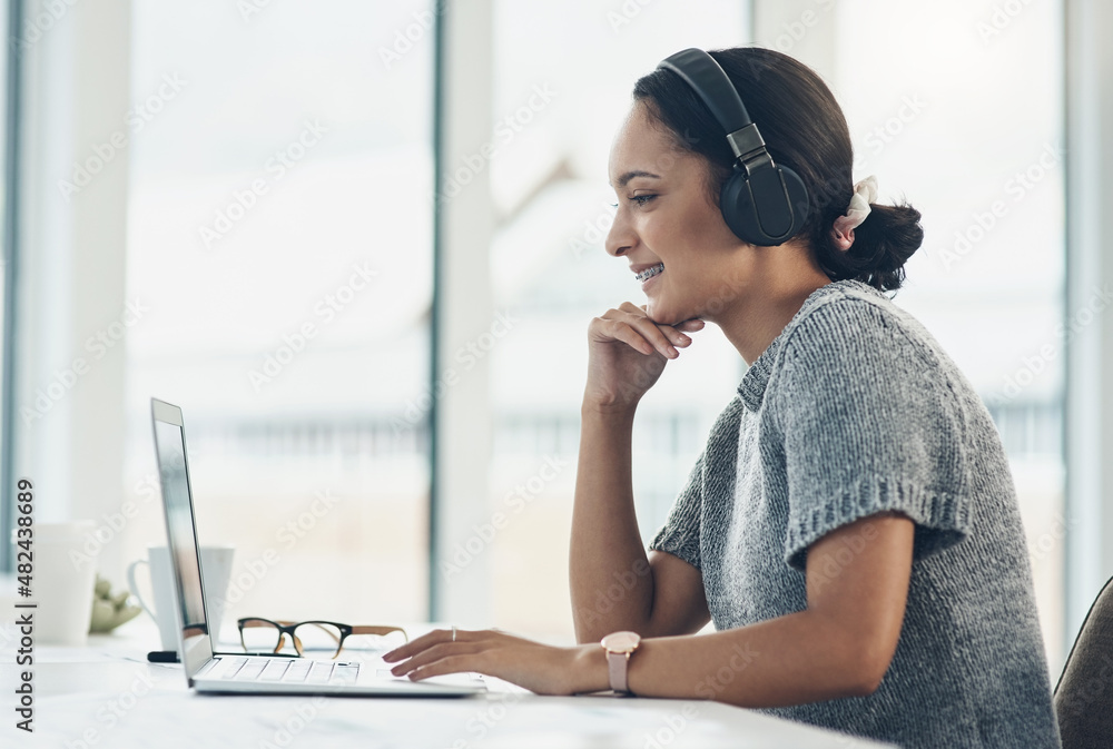 Poster playing a podcast in the background while she works