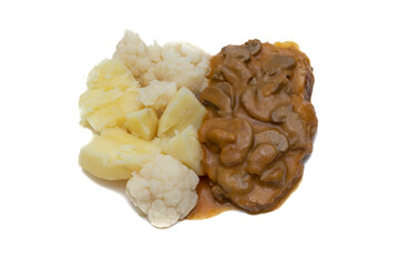 A meat dish with mushroom sauce, accompanied by potatoes with cauliflower. Delicious food concept.