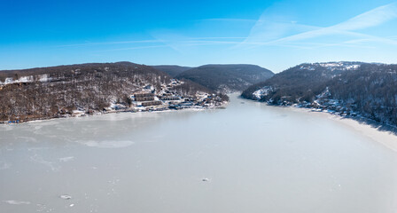 Aerial drone panorama of the frzoen and ice covered Cheat Lake looking upriver into the gorge near Morgantown, West Virginia