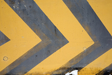 yellow and black traffic direction lines on the street