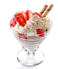 Ice cream decorated with strawberry slices on a white background