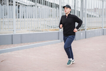 Fototapeta na wymiar young male sportsman jogger on the morning run outdoors