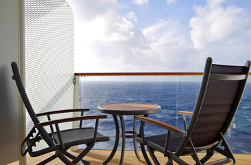 Sun loungers and deck chairs on deck around pool on modern cruiseship or cruise ship liner