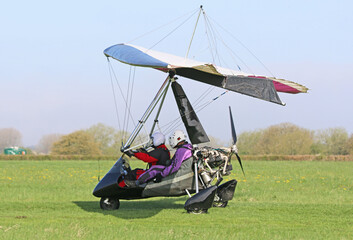 Ultralight airplane taxiing on a farm strip	