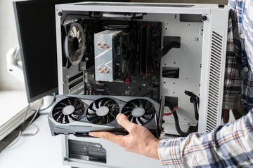 person holding a computer graphics video card. crypto mining and parts deficit