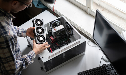 new modern powerful computer video or graphics card installed in computer by serviceman