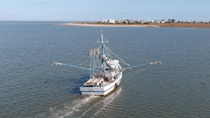 A commercial shrimping boat pulls nets off the cost of South Carolina