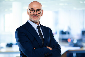 Successful businessman wearing suit and tie while standing at the office