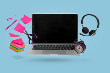Creative minimal composition made with a laptop, headphones, school supplies and alarm clock flying in the air. Back to school.