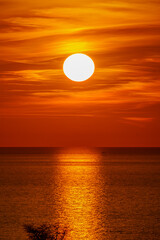 Fototapeta premium Fantastic sunset over ocean. The sun goes down over the sea. Dramatic Sunset Sky