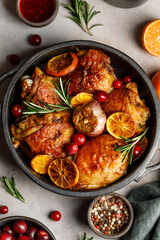 Chicken thighs baked with orange and rosemary in a ceramic dish