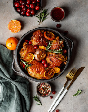 Chicken thighs baked with orange and rosemary in a ceramic dish