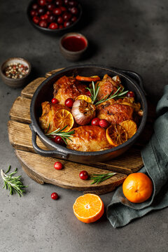 Chicken thighs baked with orange and rosemary in a ceramic dish