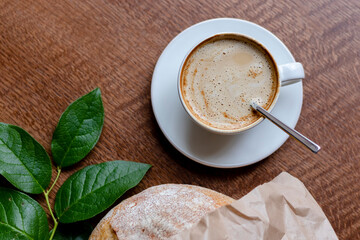 Cup of coffee latte on in a cafe on a wooden table